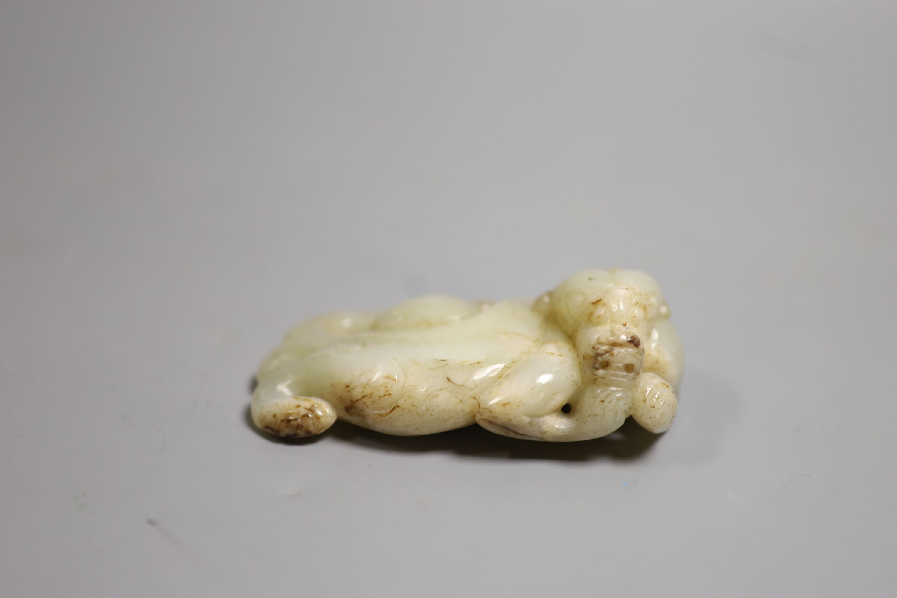 A Chinese pale celadon jade figure of a pixin, 11cm wide